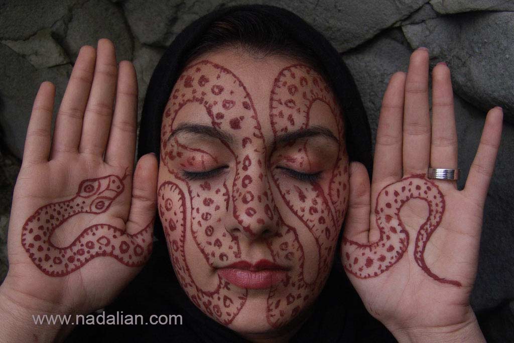 Painting by Hormuz red soils on woman face, By Ahmad Nadalian, Hormuz Island, Workshop, 2008 Director 