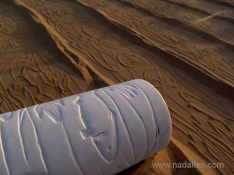 Print of Goodess and Fish by Ahmad Nadalian's cylindrical seals on the sand  beach, Hormuz Island 