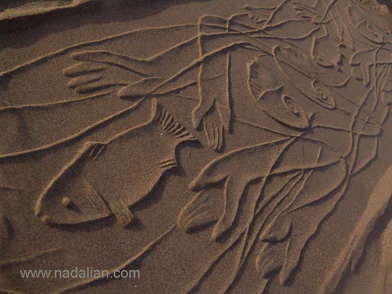 Print of Goddess and Fish by Ahmad Nadalian's cylindrical seals on the sand beach, Hormuz Island