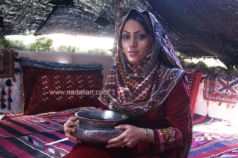 زن سنگسری با ظرف آب چشمه در داخل گوت (چادر خیلی بزرگ سیاه رنگ بافته شده از موی بز)